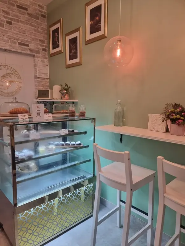 Moi Doughssier café interior showing the display counter, pendant lights and white bar seating